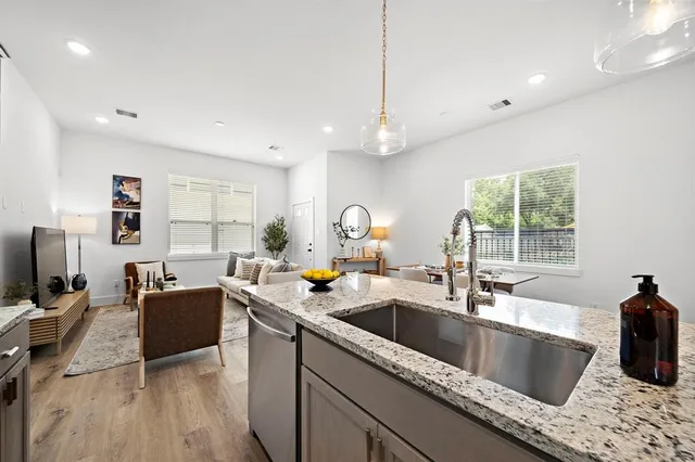 a kitchen with a sink cabinets and wooden floor