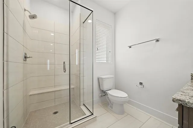 a bathroom with a shower and a toilet