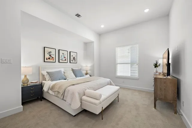 a bedroom with a bed and couch