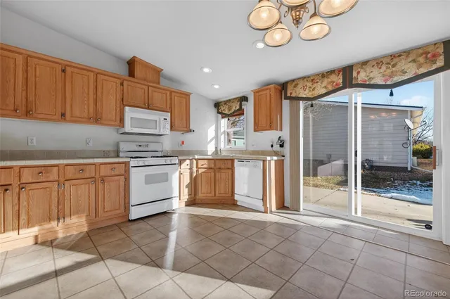 a kitchen with a refrigerator a stove and cabinets