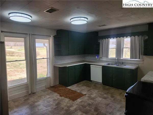 a kitchen with refrigerator and stove