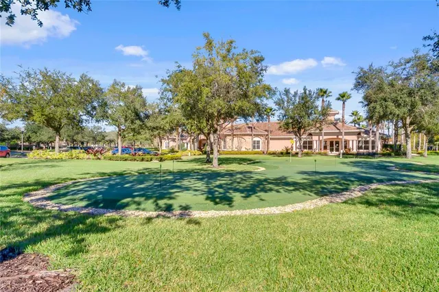 a view of a house with a big yard and potted plants
