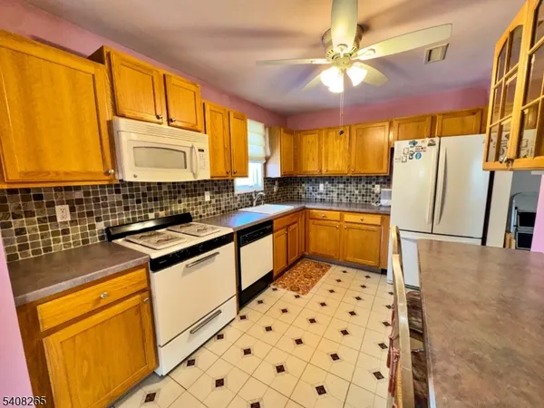 a stove top oven sitting inside of a kitchen