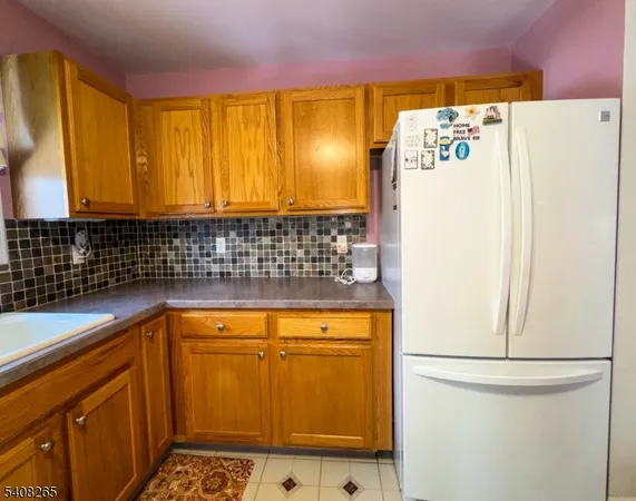 a kitchen with a stove a sink a dining table and chairs
