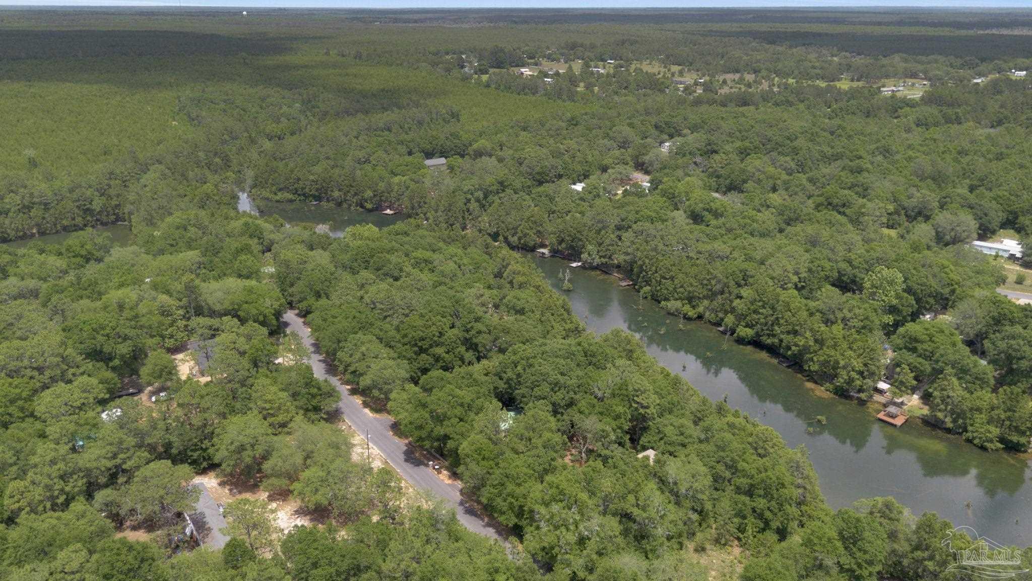 10290 West Lake Road Milton, FL 32583 - Photo 50 of 53 a view of a city with lush green forest