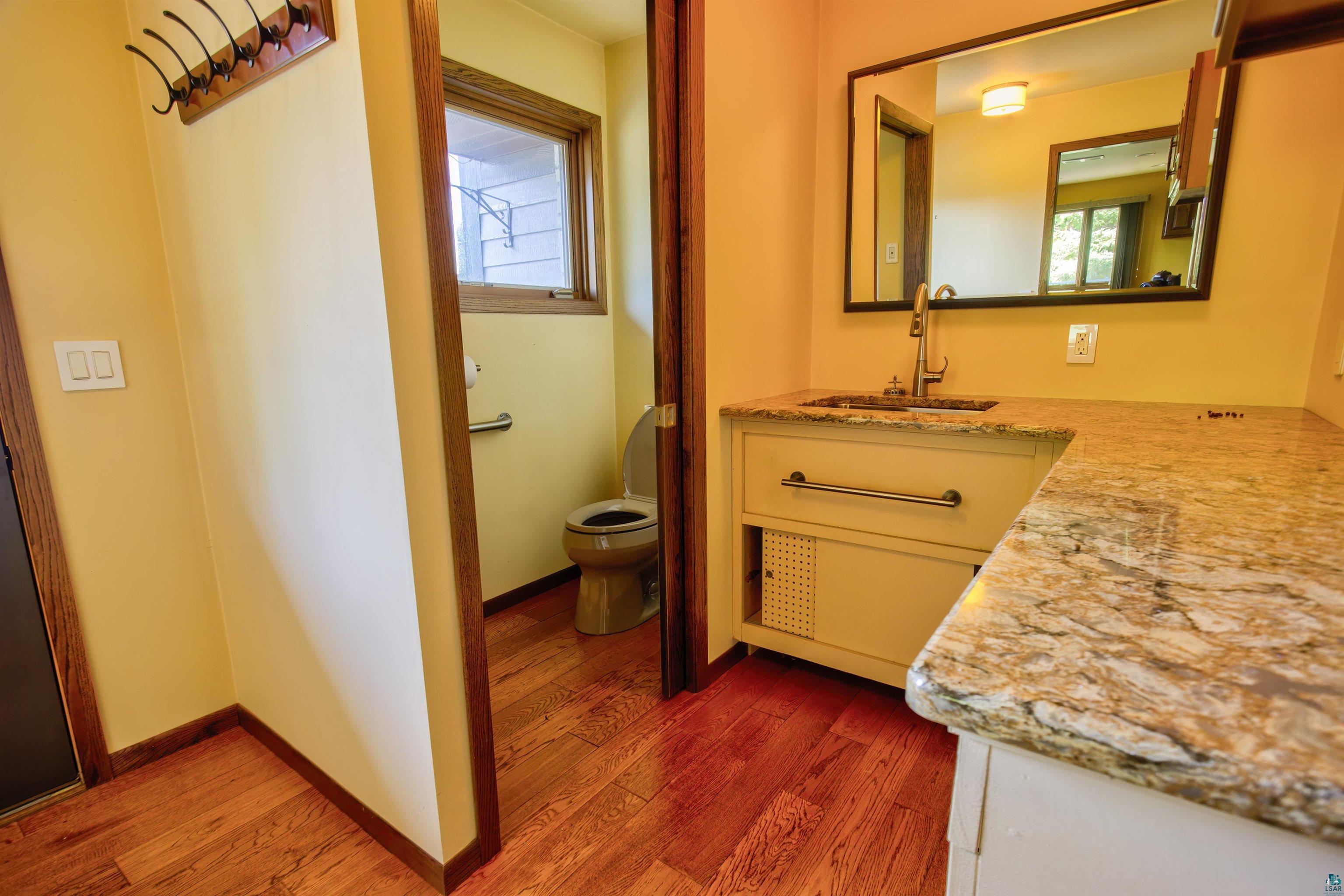 1933 West Shagawa Road Ely, MN 55731 - Photo 14 of 46 Bathroom with vanity, hardwood / wood-style floors, and toilet