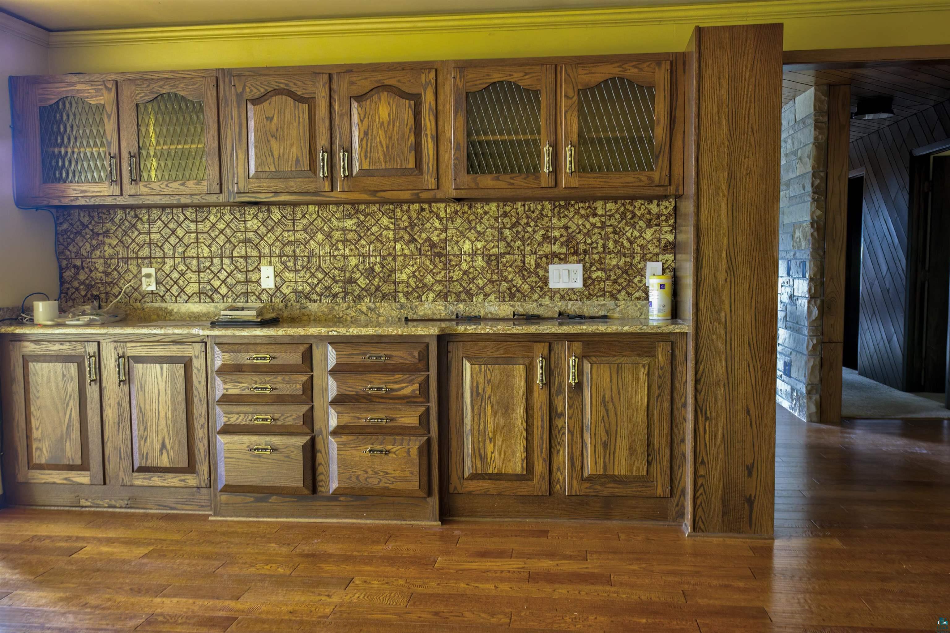 1933 West Shagawa Road Ely, MN 55731 - Photo 8 of 46 Kitchen featuring crown molding, dark hardwood / wood-style floors, and tasteful backsplash