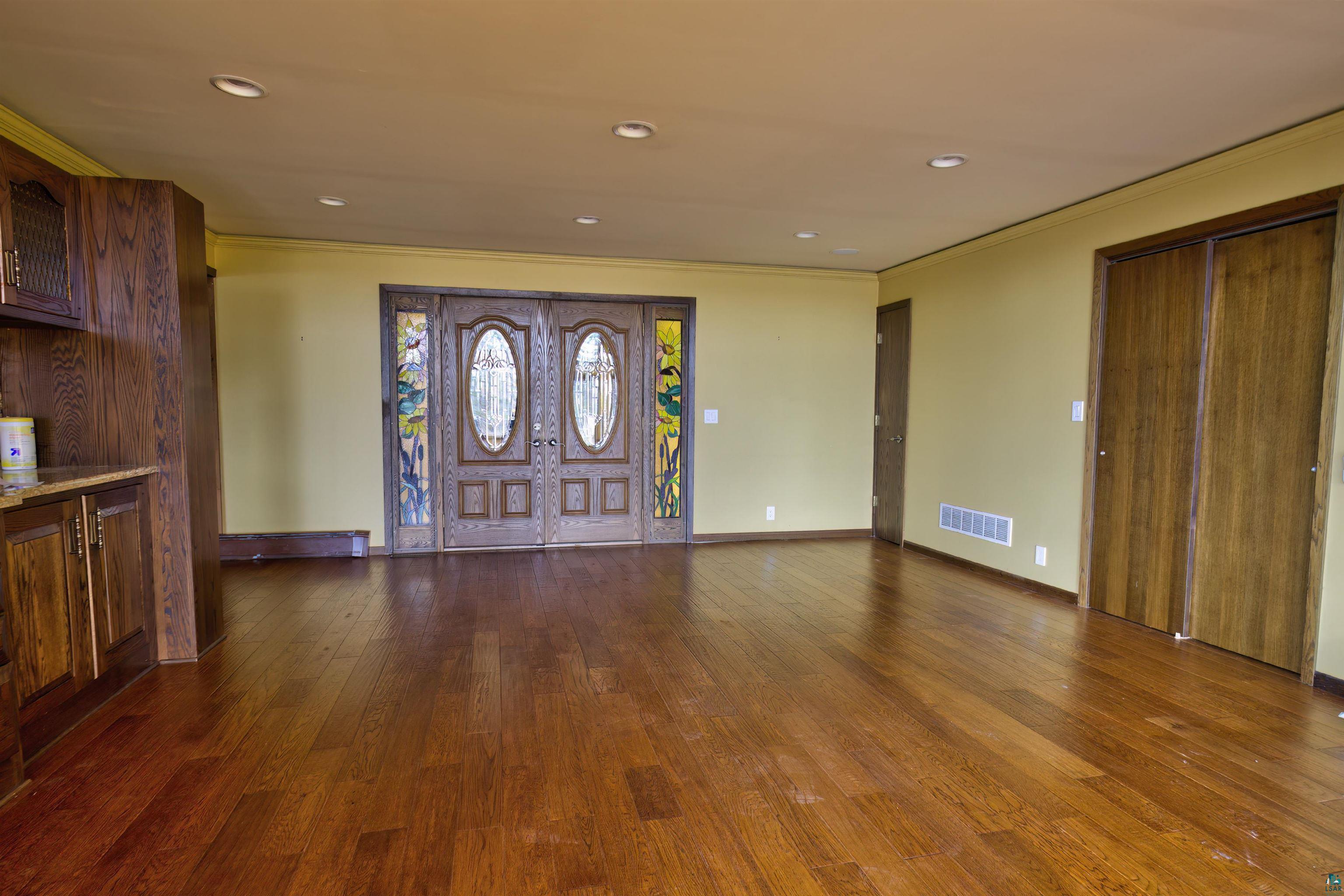 1933 West Shagawa Road Ely, MN 55731 - Photo 9 of 46 Foyer entrance featuring ornamental molding and hardwood / wood-style flooring