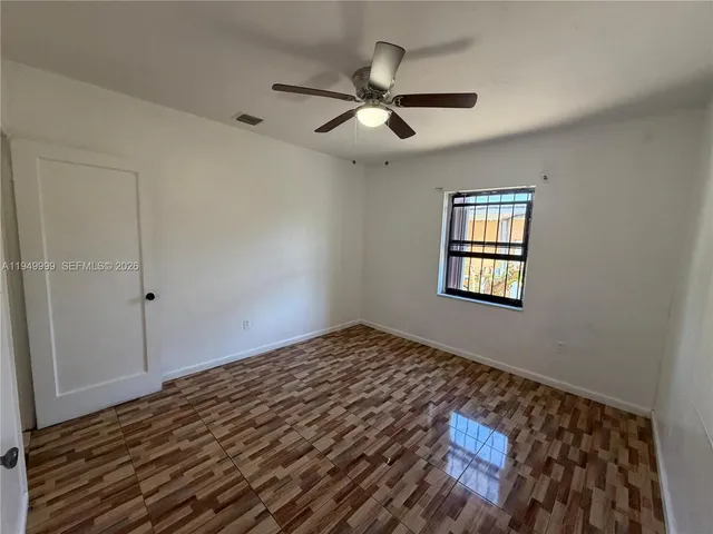 a view of a livingroom with a ceiling fan and wooden floor