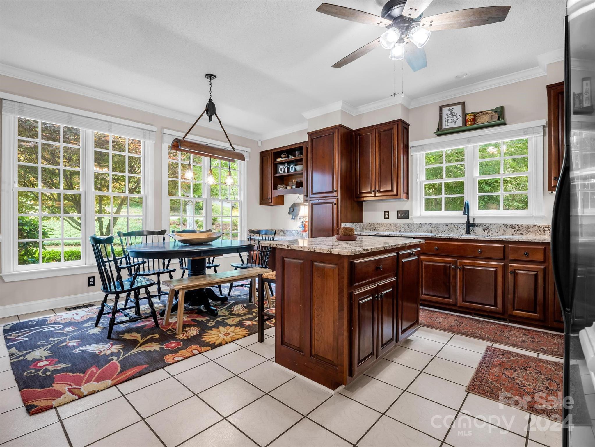 107 Fairforest Drive Rutherfordton, NC 28139 - Photo 11 of 33 a kitchen with a stove a sink a dining table and chairs