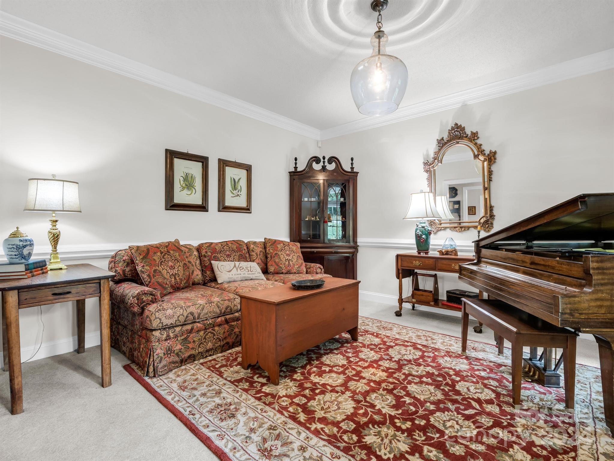 107 Fairforest Drive Rutherfordton, NC 28139 - Photo 6 of 33 a living room with furniture a rug and a chandelier