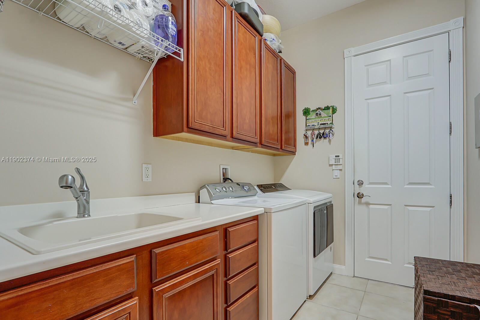 1053 Big Pine Way Jupiter, FL 33458 - Photo 23 of 48 a bathroom with a sink and cabinets