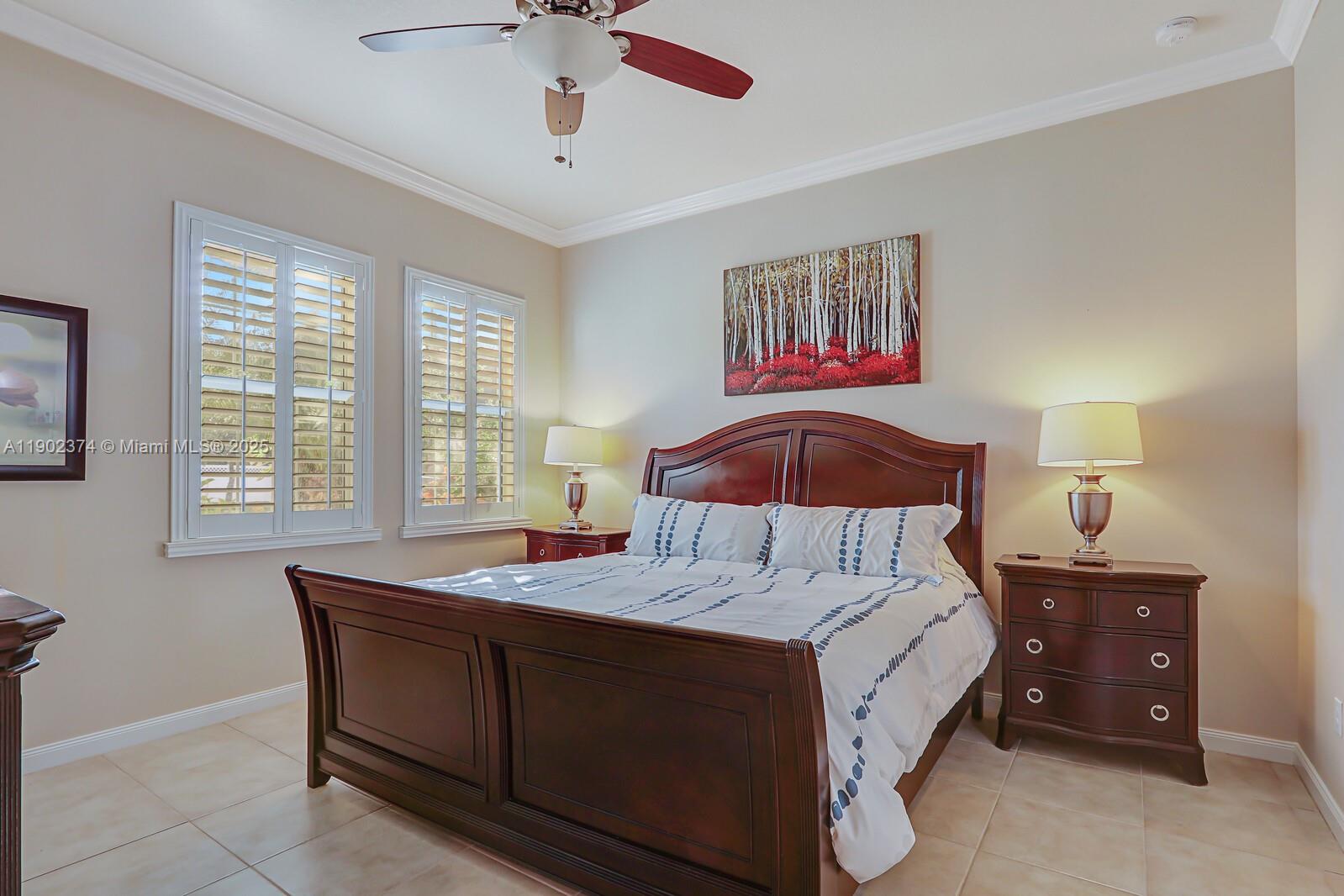 1053 Big Pine Way Jupiter, FL 33458 - Photo 24 of 48 a bedroom with a bed and a chandelier