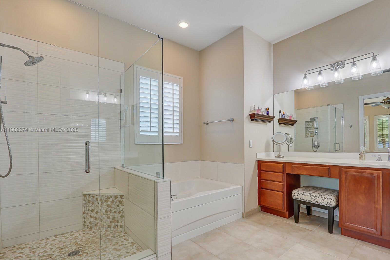 1053 Big Pine Way Jupiter, FL 33458 - Photo 27 of 48 a bathroom with a bathtub and a shower