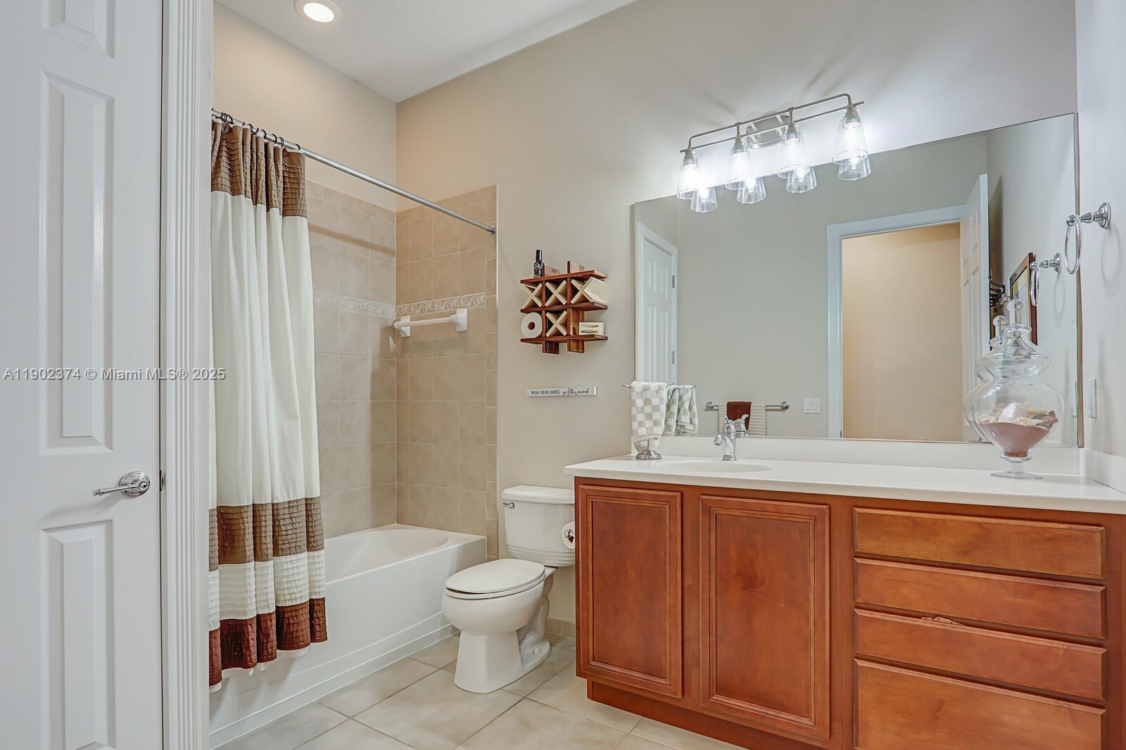 1053 Big Pine Way Jupiter, FL 33458 - Photo 30 of 48 a bathroom with a sink a toilet and shower