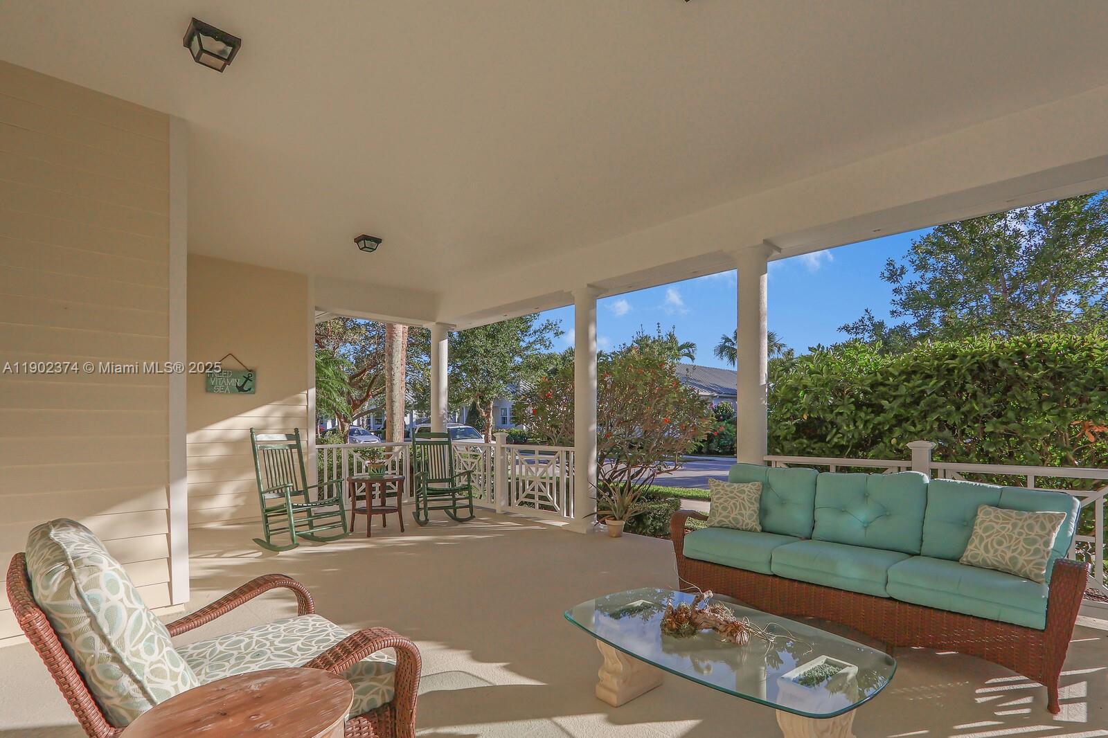 1053 Big Pine Way Jupiter, FL 33458 - Photo 3 of 48 a living room with furniture and a floor to ceiling window