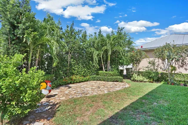 a view of a backyard with table and chairs with wooden fence