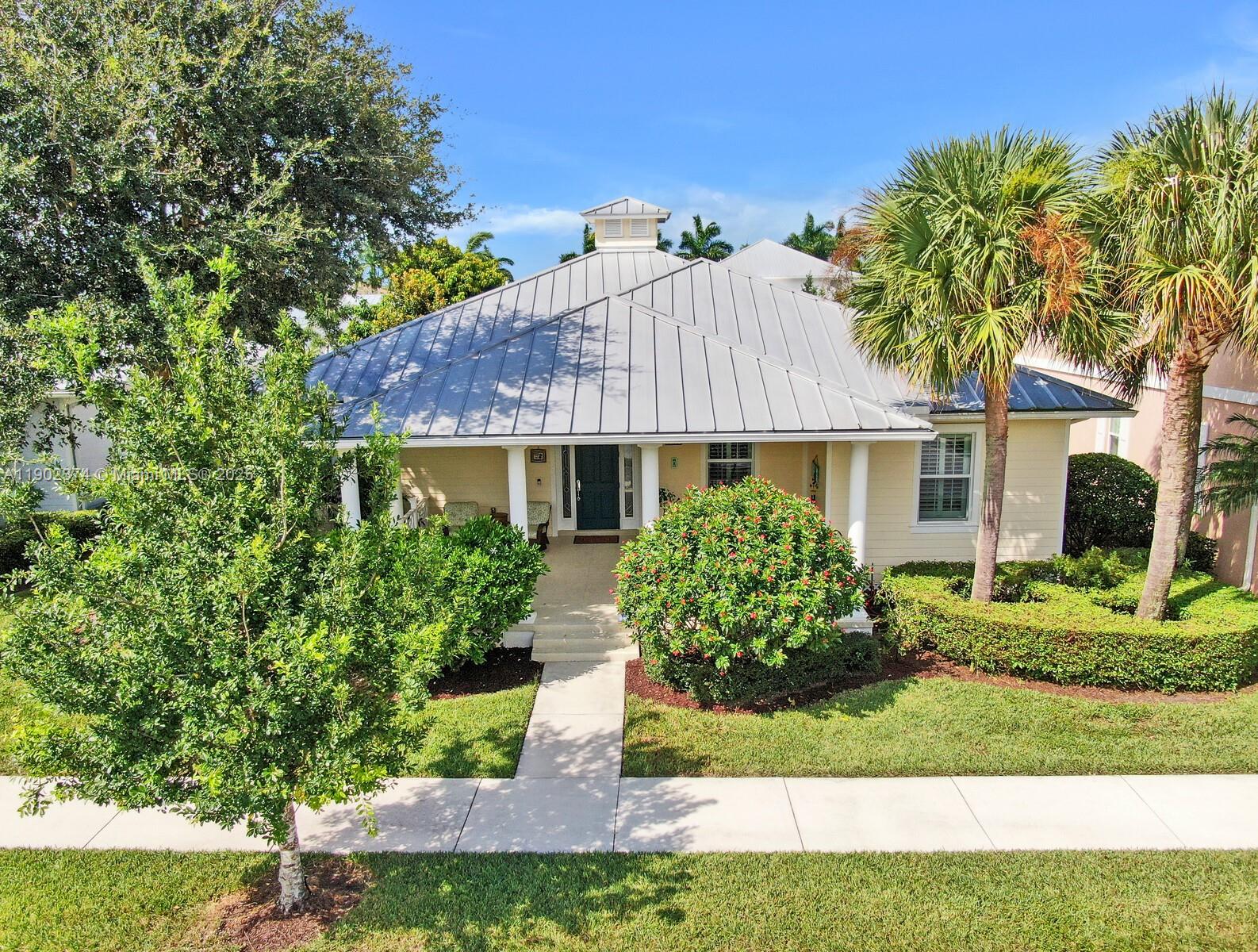 1053 Big Pine Way Jupiter, FL 33458 - Photo 35 of 48 a front view of a house with a yard