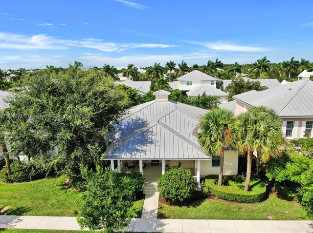 an aerial view of residential houses with outdoor space and street view