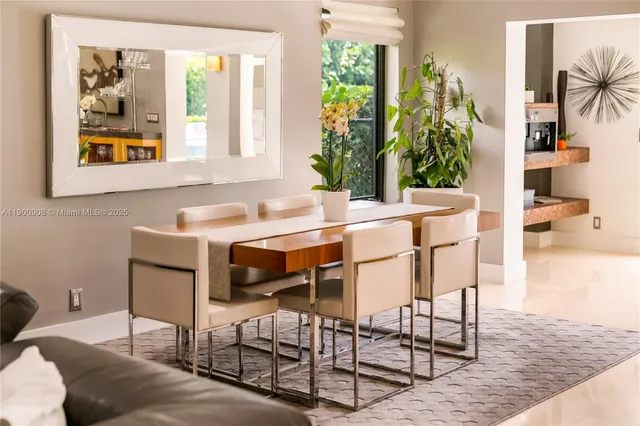 a view of a dining room with furniture and a potted plant