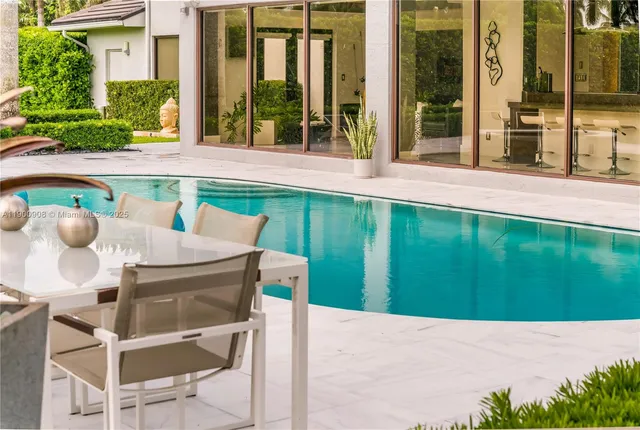 a backyard of a house with table and chairs