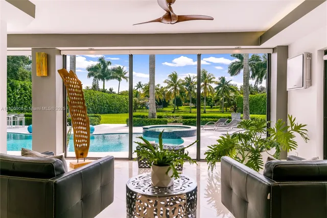 a view of a porch with chairs and potted plants