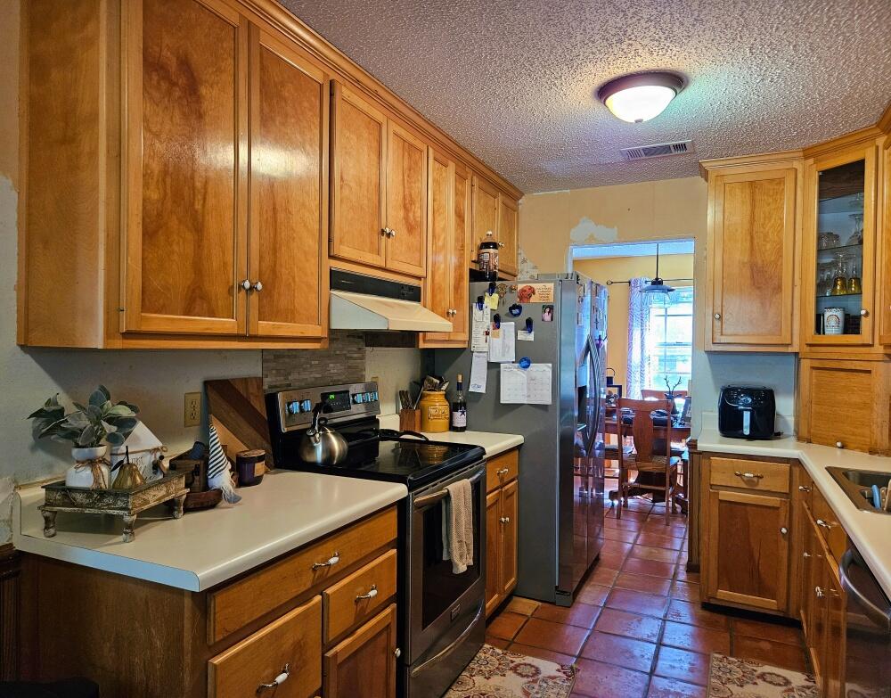4017 Bear Creek Road Crestview, FL 32539 - Photo 6 of 30 a kitchen with stainless steel appliances a sink a stove and cabinets
