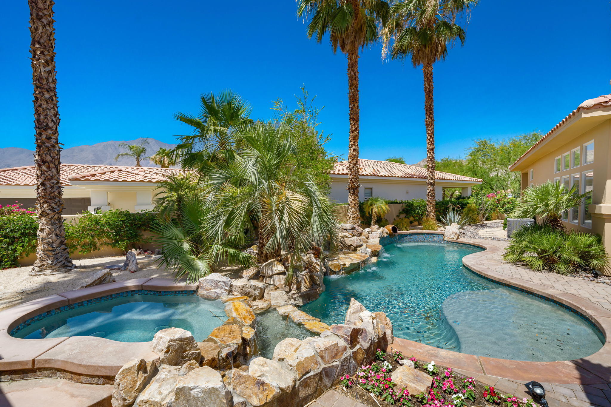 a view of a lake with couches and wooden fence