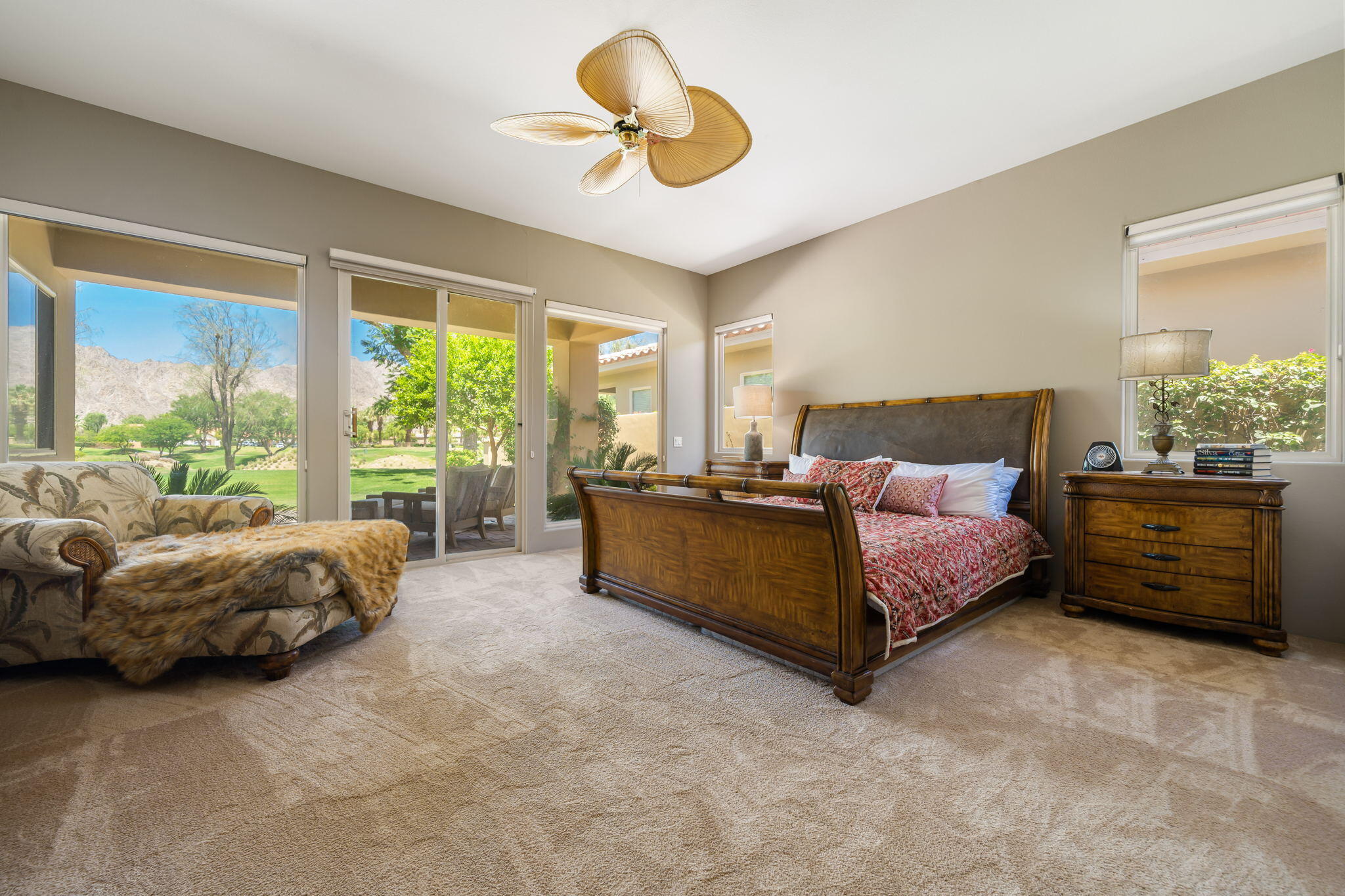 57355 Interlachen La Quinta, CA 92253 - Photo 16 of 35 a spacious bedroom with a bed and a chandelier