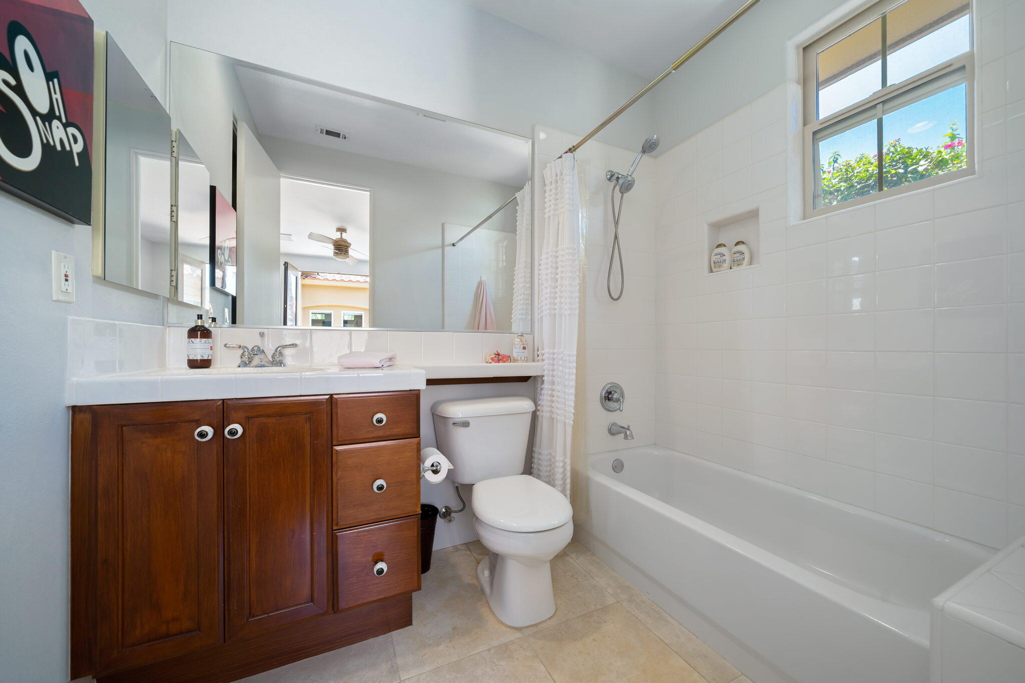 57355 Interlachen La Quinta, CA 92253 - Photo 25 of 35 a bathroom with a granite countertop sink toilet a large mirror a bathtub and shower