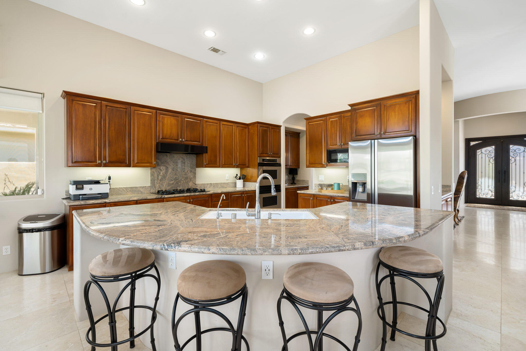 57355 Interlachen La Quinta, CA 92253 - Photo 8 of 35 a kitchen with granite countertop a table chairs stove and cabinets
