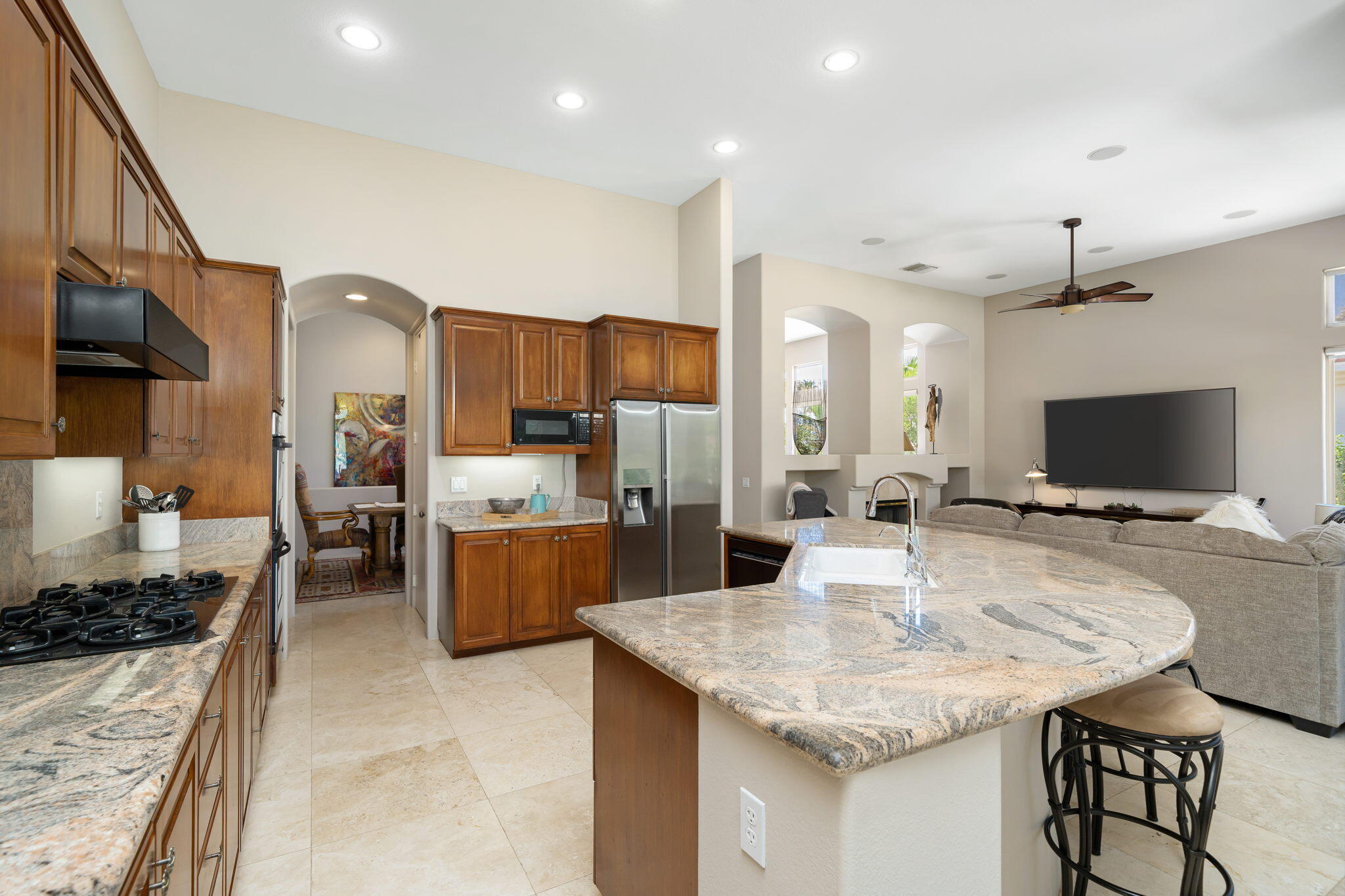 57355 Interlachen La Quinta, CA 92253 - Photo 10 of 35 a kitchen with a kitchen island a sink stainless steel appliances and cabinets