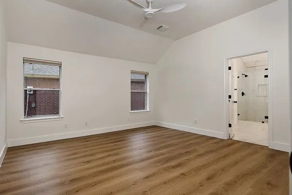 wooden floor in an empty room with a fireplace