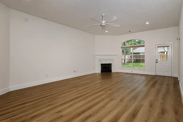 wooden floor in an empty room with a window