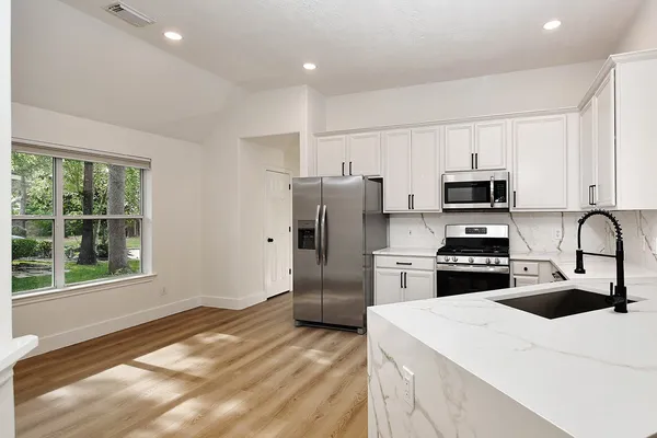 a kitchen with a refrigerator stove and microwave