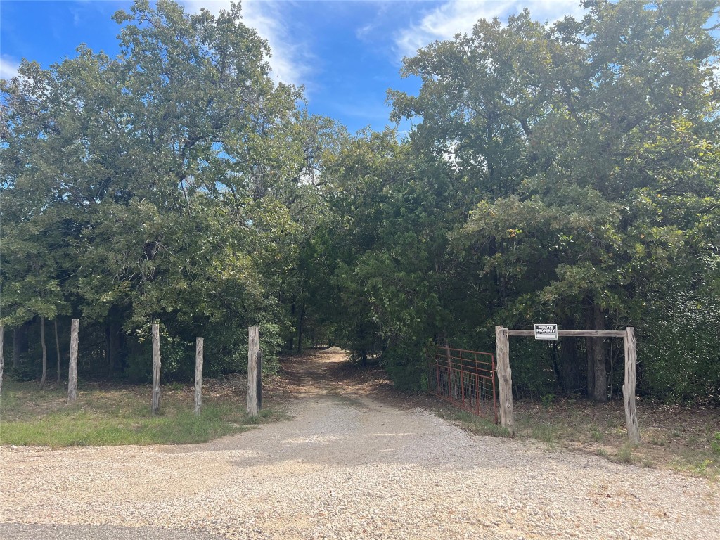 680 Hidden Oaks Drive Elgin, TX 78621 - Photo 2 of 6 a backyard of a house with lots of green space