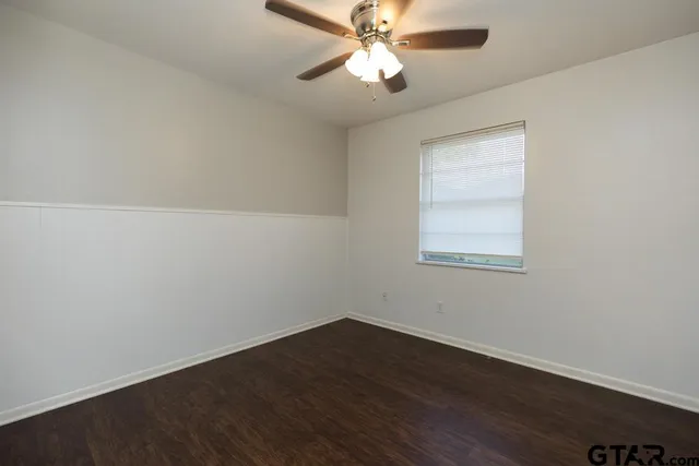 a view of a room with wooden floor and windows