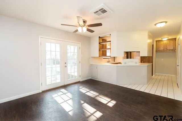 a view of a kitchen with a sink dishwasher a kitchen island with wooden floor