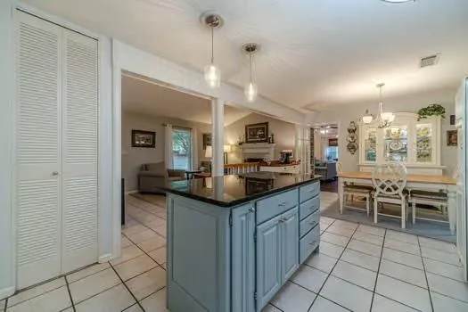 a view of a dining room with furniture wooden floor and chandelier