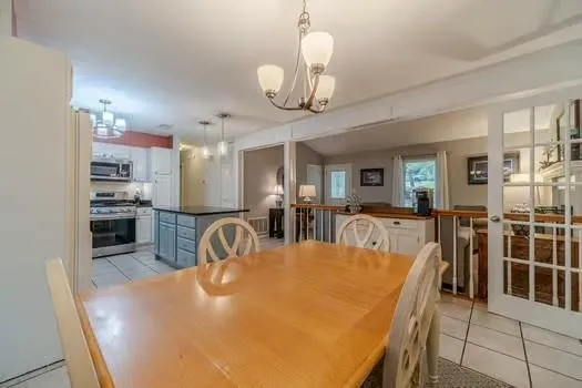 a living room with furniture a flat screen tv and a large window