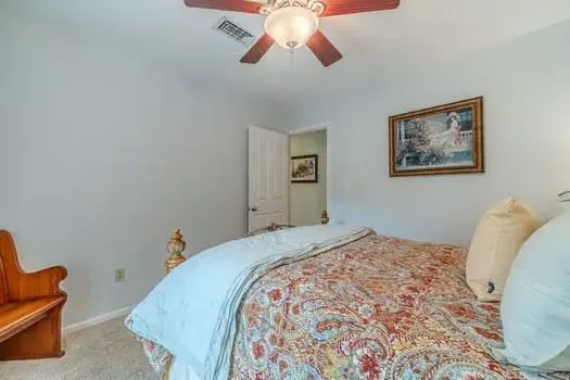 a bedroom with a large bed and a window