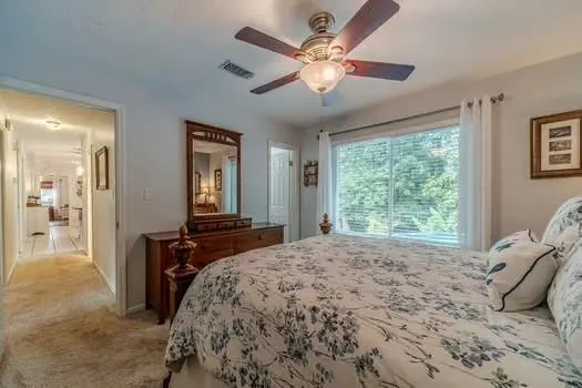 a bathroom with a granite countertop sink toilet a mirror and shower