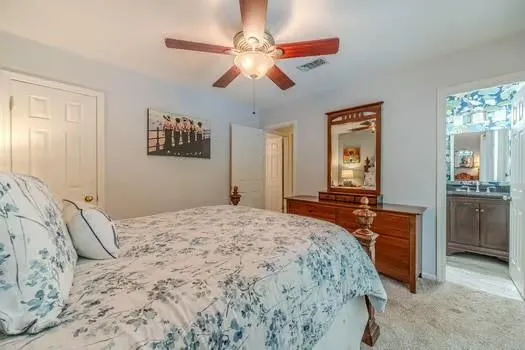 a view of a house with a yard and large tree