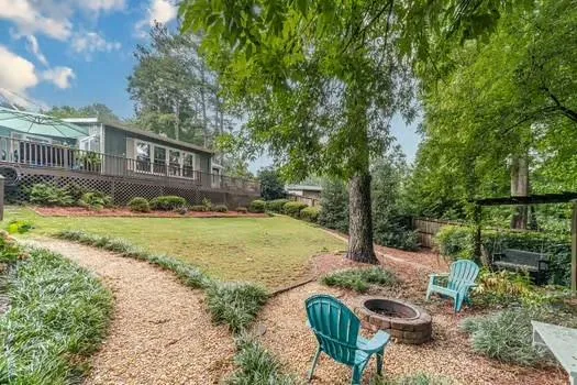 a view of a patio with table and chairs with wooden floor and fence