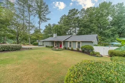 a front view of a house with yard and green space
