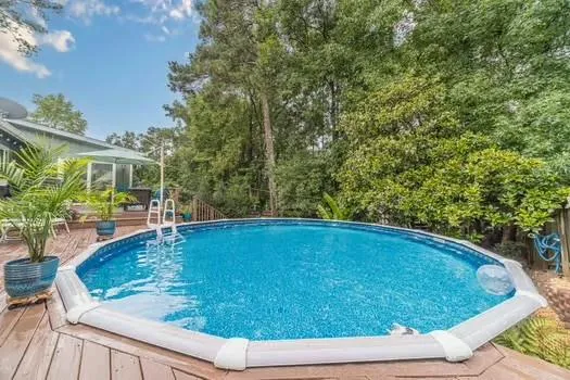 a view of a backyard with sitting area