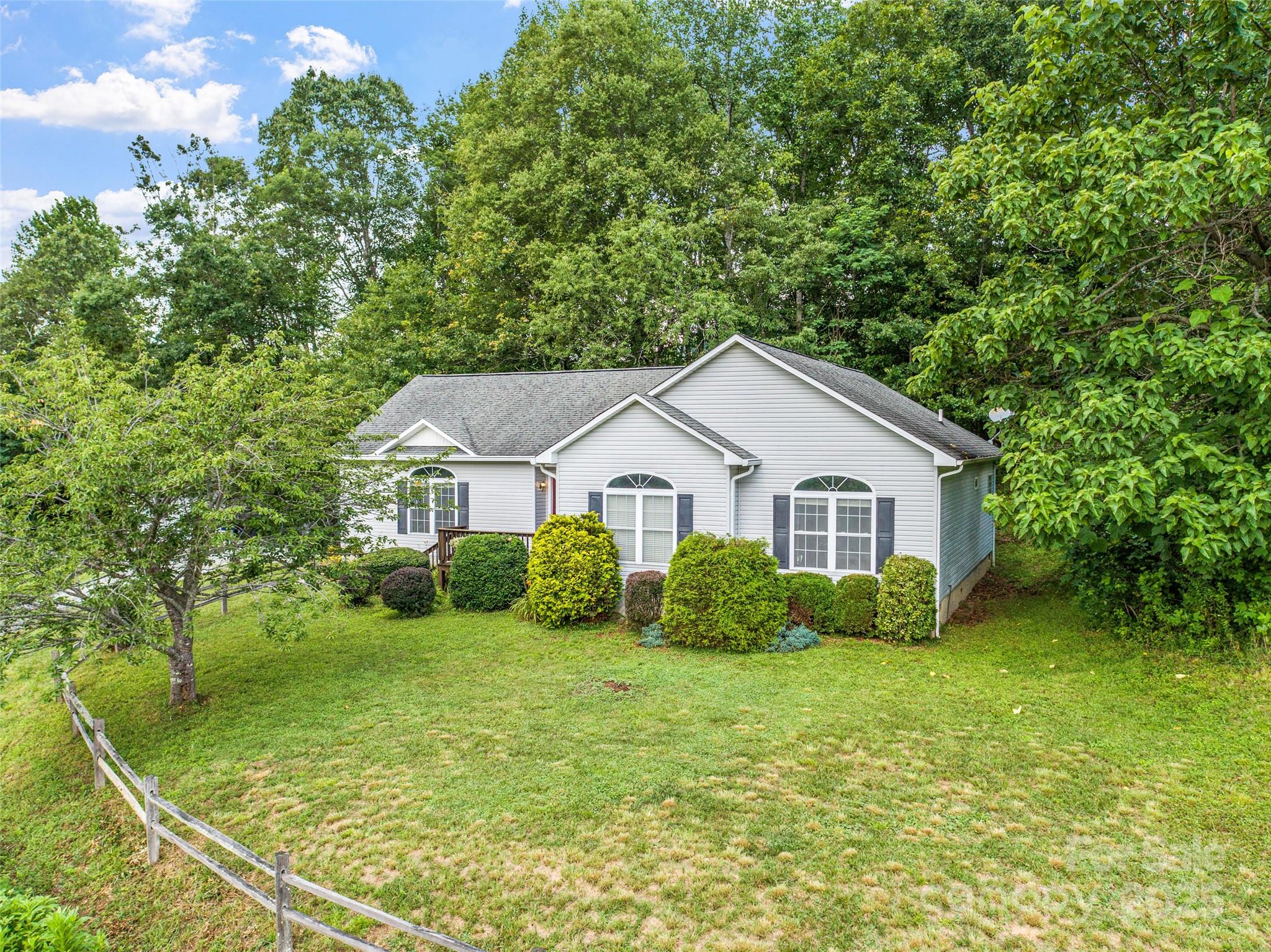 a view of a house with yard and a garden
