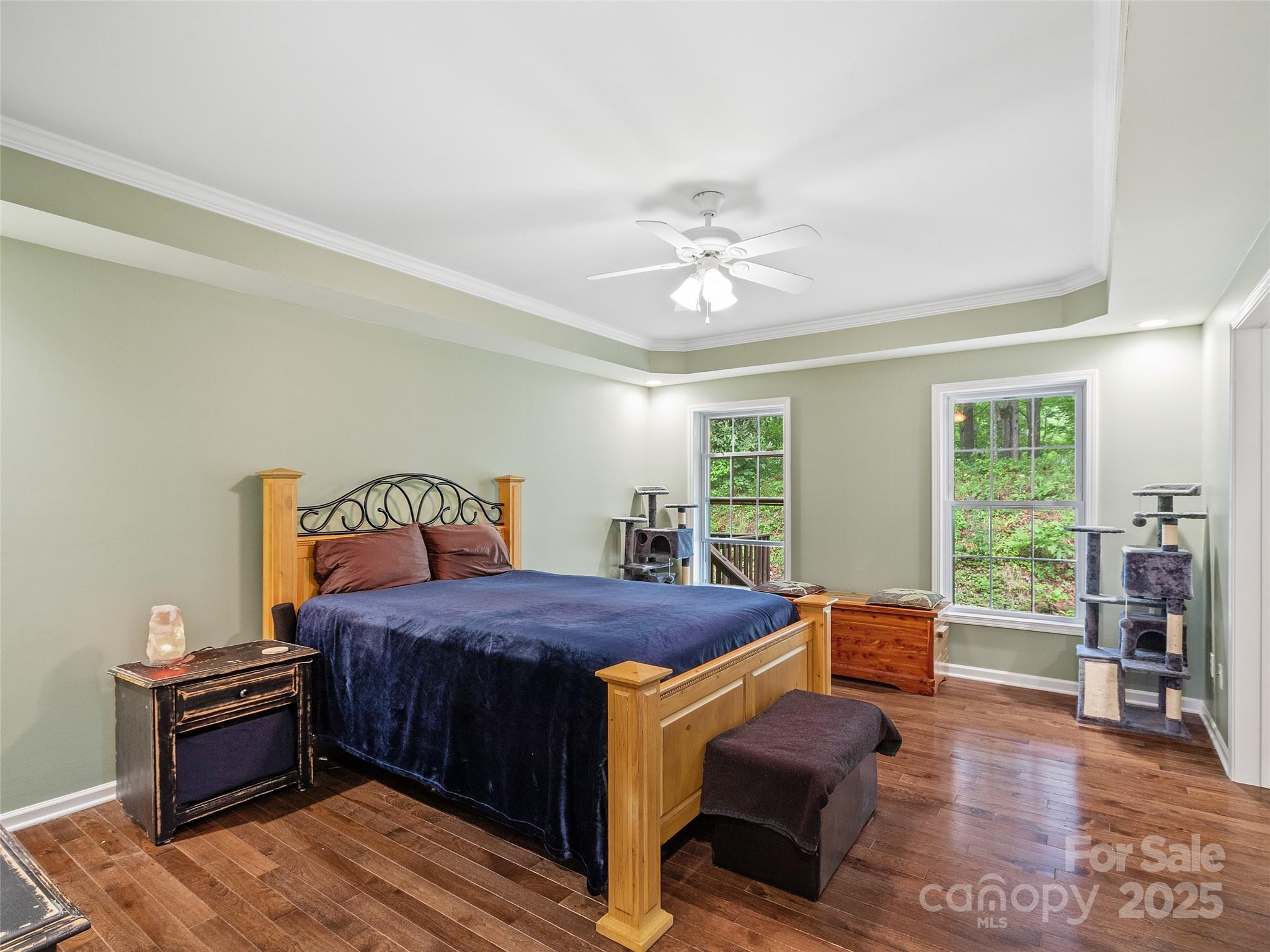 161 Blue Rock Road Burnsville, NC 28714 - Photo 18 of 48 a bedroom with a bed and wooden floor