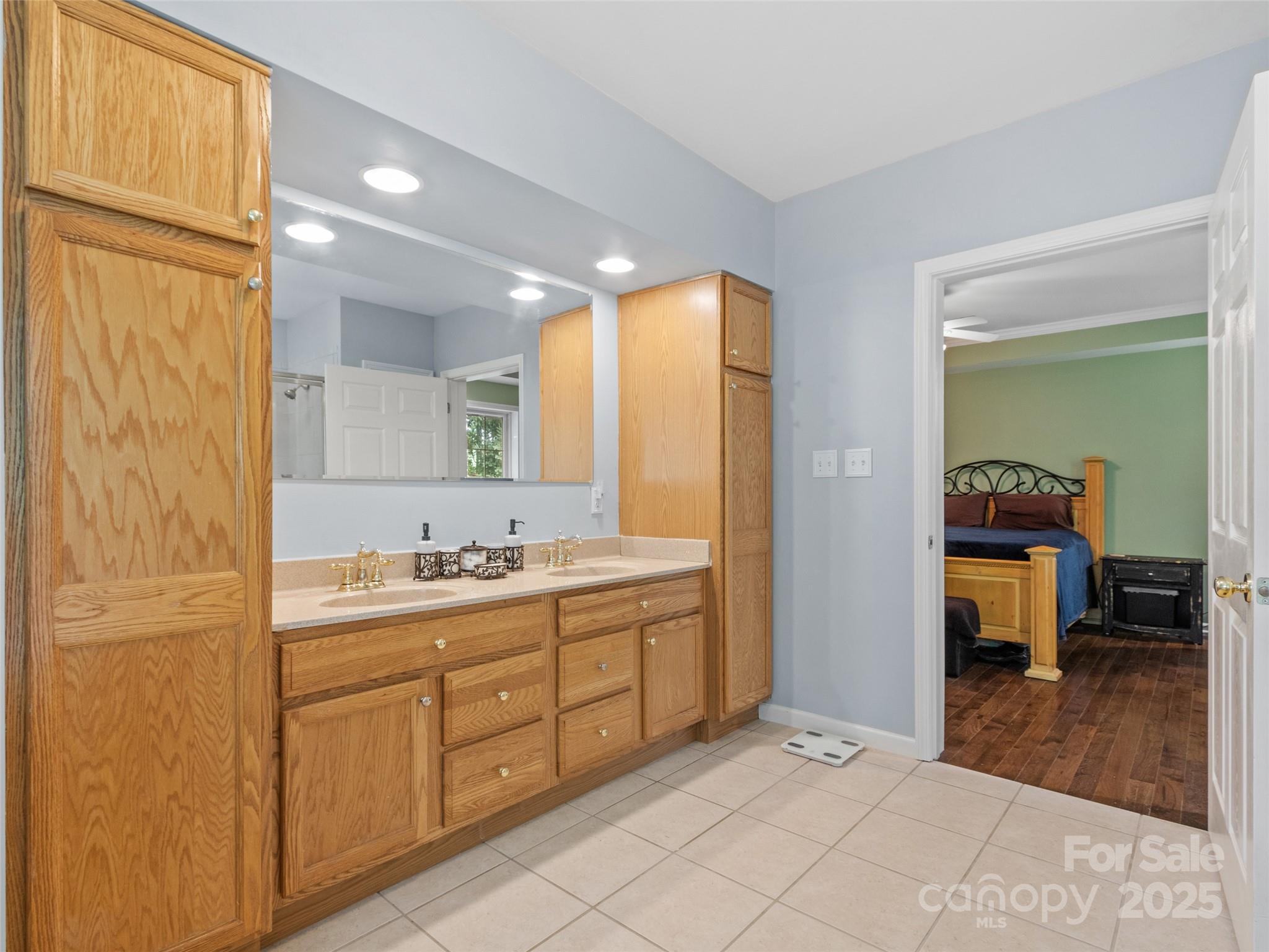 161 Blue Rock Road Burnsville, NC 28714 - Photo 23 of 48 a spacious bathroom with a double vanity sink and a mirror