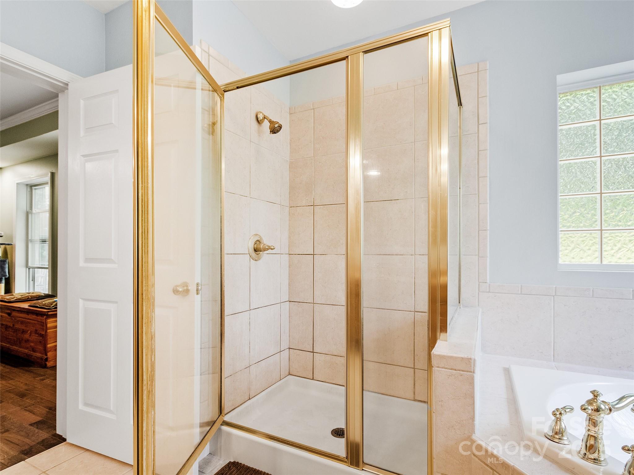 161 Blue Rock Road Burnsville, NC 28714 - Photo 25 of 48 a bathroom with a shower and a sink
